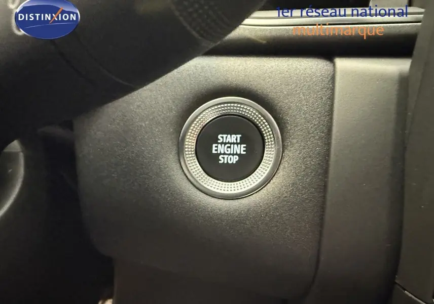 Bouton Start Engine Stop en gros plan sur le tableau de bord du Renault Captur gris Cassiopée 2025.