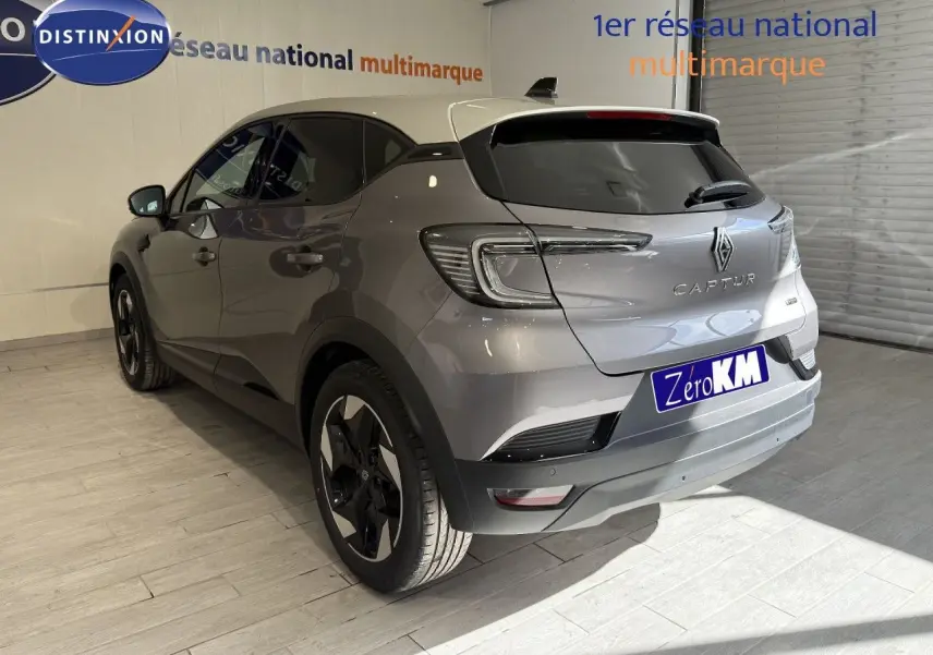 Vue 3/4 arrière droite du Renault Captur 2025 gris Cassiopée métal avec toit gris et jantes bi-ton.