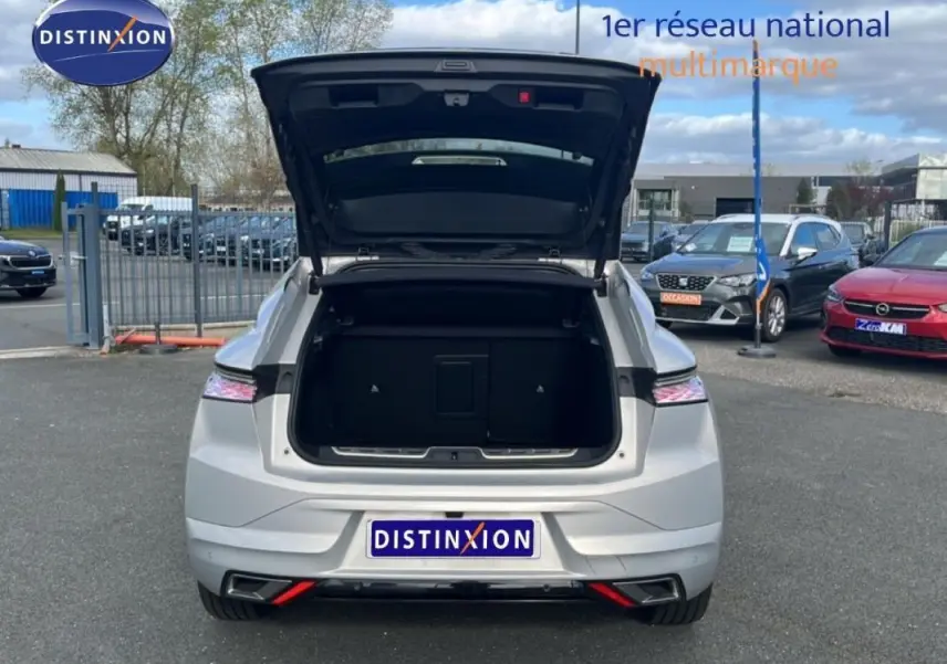 Vue arrière d'une DS4 blanche 2024 avec coffre ouvert, soulignant ses feux arrière LED et lignes modernes.