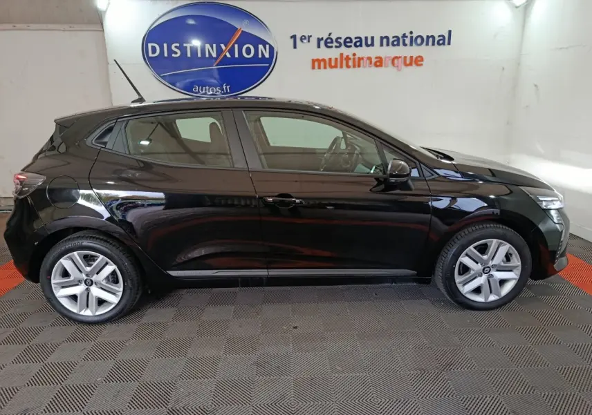 Profil côté gauche d'une Renault Clio noire Evolution Blue dCi 100 2025, en intérieur sur sol damier gris et rouge.