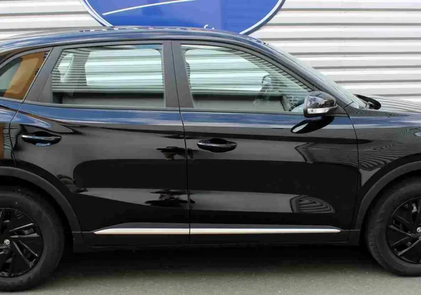 Vue intérieure côté gauche montrant les sièges avant en tissu gris et noir du MG ZS Pebble Black 2026.