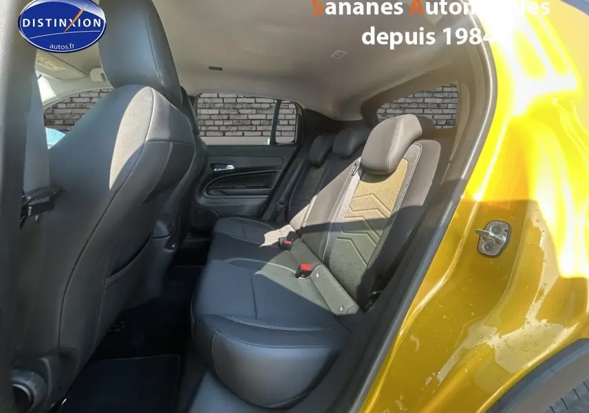 Vue intérieure arrière côté droit du Jeep Avenger jaune foncé, montrant les sièges arrière en tissu et cuir noir.