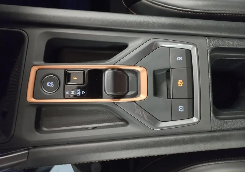 Gros plan sur la console centrale noire avec levier de vitesses automatique et cadre cuivre du CUPRA Leon Phase 2.