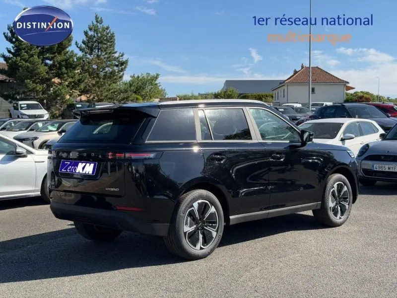 Vue 3/4 arrière droite du JAECOO J5 hybride noir Carbon Crystal Black métal avec toit panoramique et jantes alu.