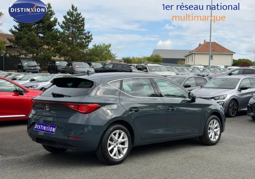 SEAT Leon 2.0 TDI gris magnétique vue 3/4 arrière droit sur parking avec jantes alu et feux LED.