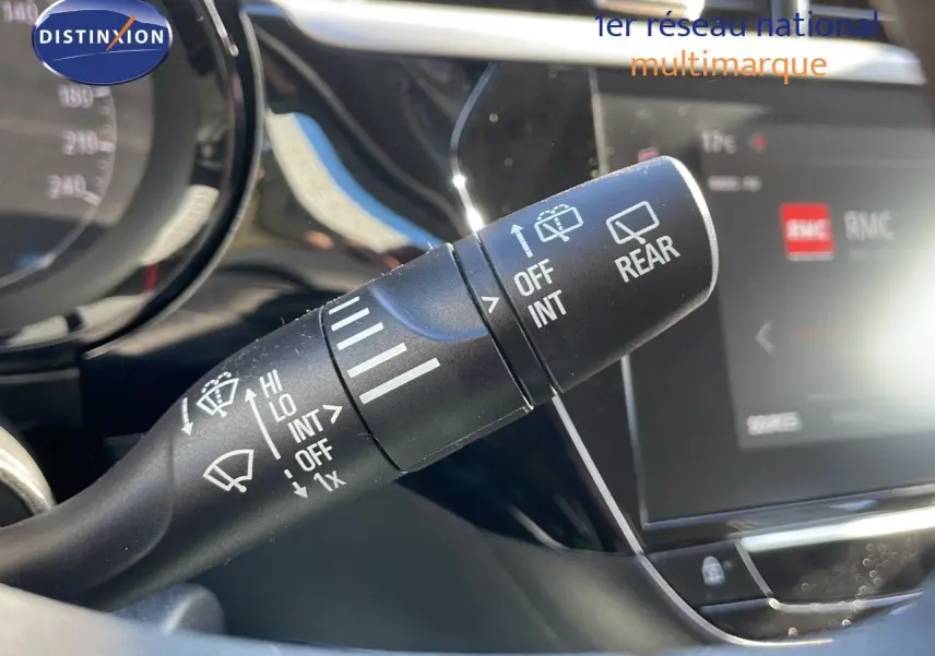 Gros plan sur la manette d'essuie-glace à gauche du volant dans l'habitacle d'une Opel Corsa blanc glacier 2022.