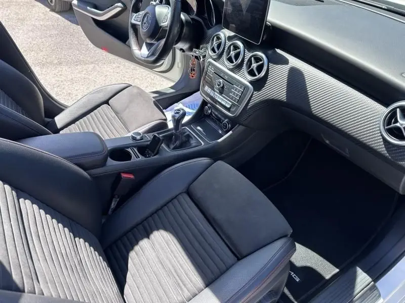 Vue intérieure côté conducteur de la Mercedes Classe A 200 d Fascination 2017, avec sellerie noire et console centrale à boîte manuelle.