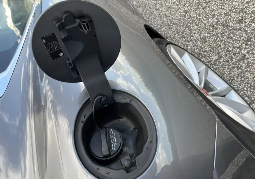 Détail de la trappe à carburant ouverte côté gauche sur Jaguar F-TYPE II Coupé 2.0T 2018 couleur Corris Grey.