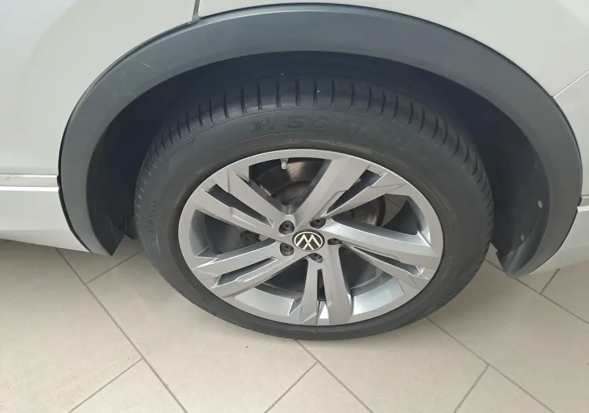 Gros plan sur la roue avant droite du Volkswagen Tiguan 2024 couleur Reflet d'Argent avec jante alliage R-Line.