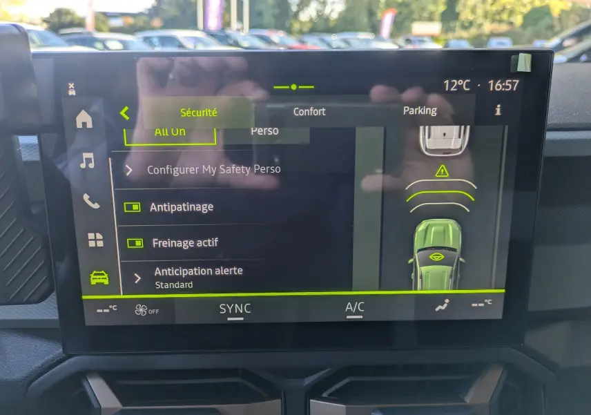 Écran tactile du tableau de bord du Dacia Bigster Hybrid 155 Extreme affichant les réglages de sécurité et assistance au stationnement.
