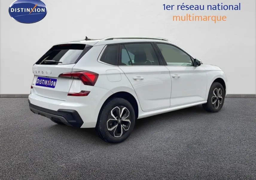 Vue 3/4 arrière droite d'un Skoda Kamiq blanc glacier 2025 avec jantes alliage et feux arrière LED distinctifs.