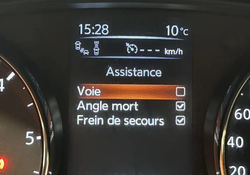Affichage du tableau de bord de la Nissan Pulsar gris, montrant les options d'assistance avec angle mort et frein de secours activés.