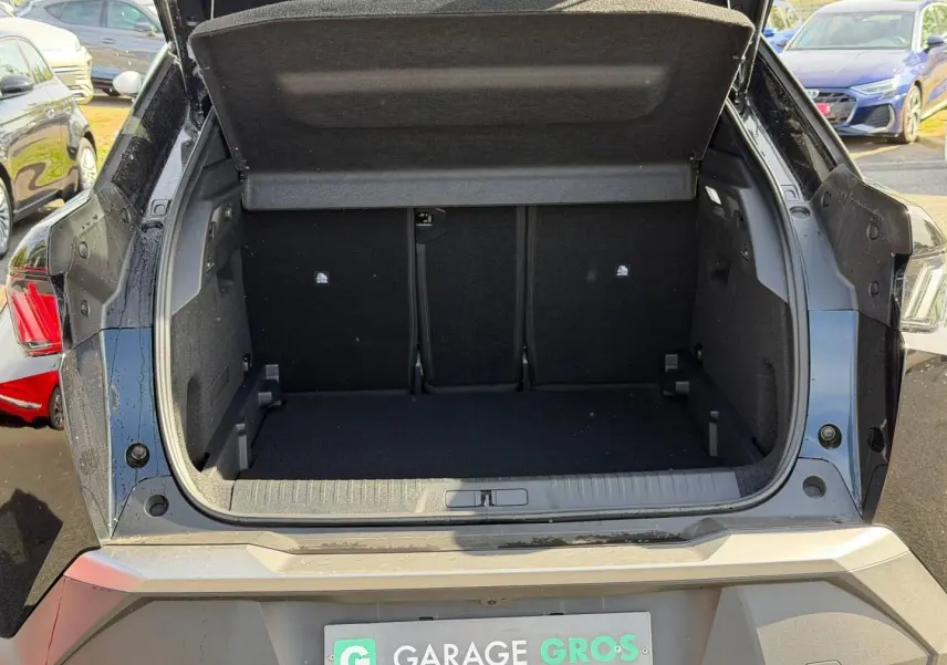 Coffre ouvert vu de l’arrière d’un Peugeot 3008 noir Perla Nera, montrant l’espace de chargement vide.