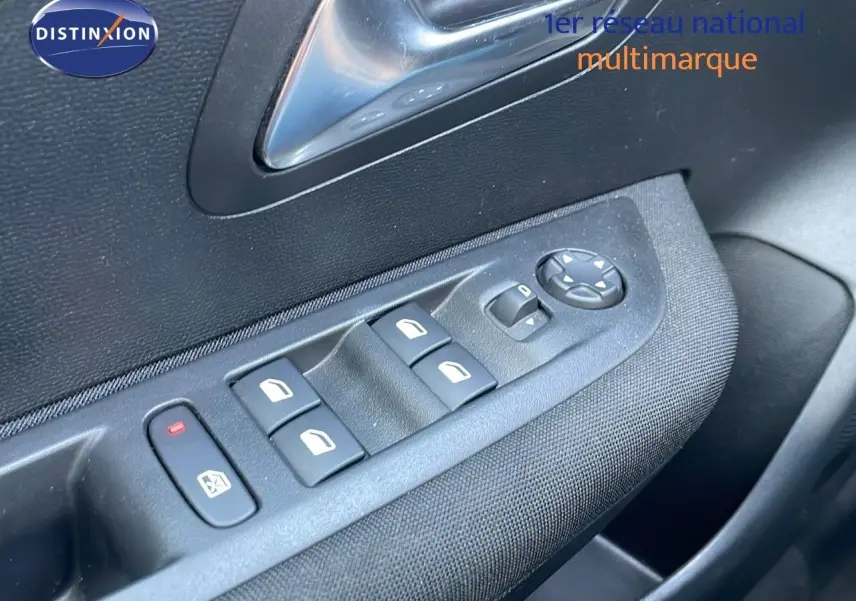 Gros plan sur les commandes des vitres électriques et rétroviseurs côté conducteur d'une Peugeot 208 2024 finition Active.