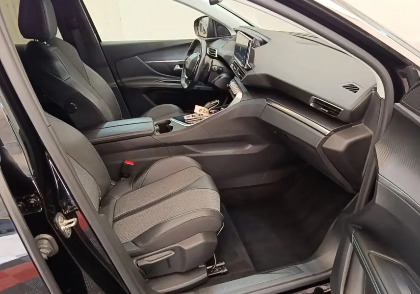 Intérieur noir du Peugeot 3008 PureTech 130, vue côté passager avant avec sièges cuir et tableau de bord moderne.