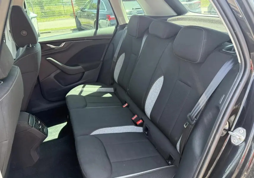 Vue intérieure sur la banquette arrière droite du Skoda Kamiq noir Magic nacré avec sièges tissu bicolores gris et noir.