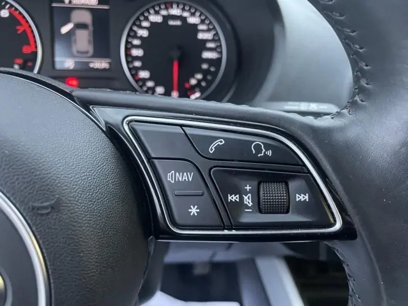 Gros plan sur les commandes au volant côté droit de l'Audi Q2 blanc 30 TFSI 116 SPORT LIMITED 2020, avec boutons navigation et appel.