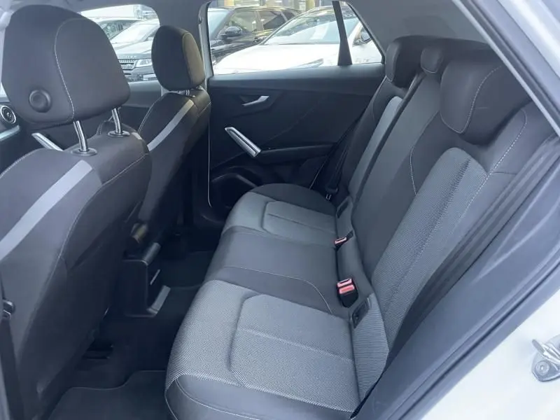 Vue intérieure côté droit des sièges arrière en tissu gris et noir de l'Audi Q2 blanc 30 TFSI 116 SPORT LIMITED 2020.