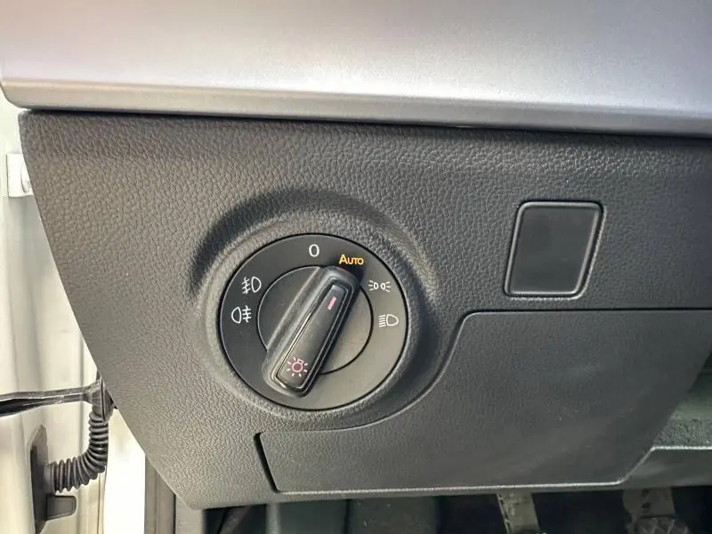 Commande des feux en gros plan sur le tableau de bord noir d'une SEAT IBIZA 1.0 TSI 115cv FR, intérieur sobre.