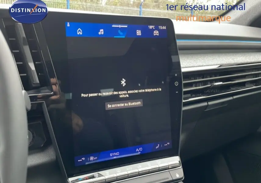 Écran tactile central du tableau de bord du Renault Espace 2025, finition noire avec commandes climatisation visibles.