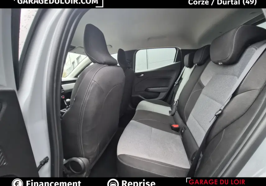 Vue intérieure arrière côté gauche de la Renault Clio gris clair, montrant la banquette bi-ton et les dossiers des sièges avant.