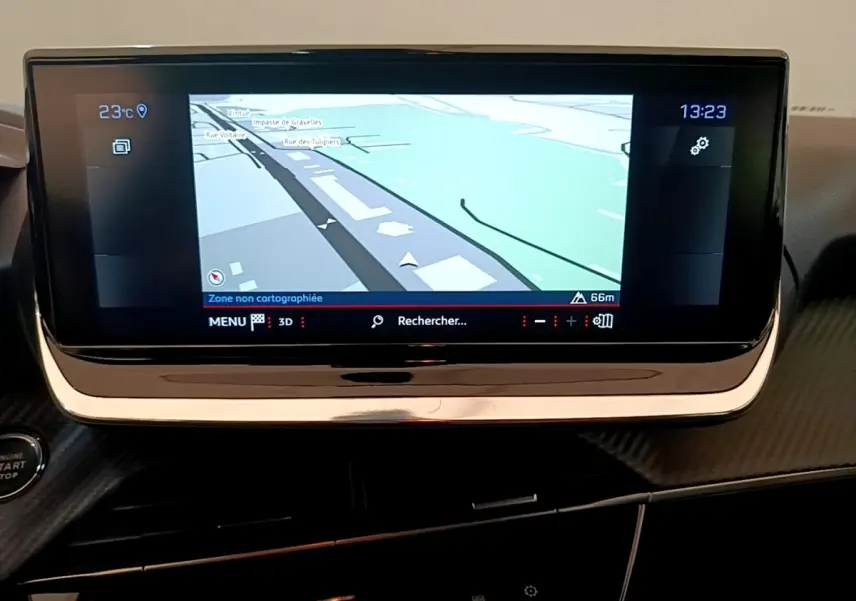 Écran tactile de navigation 10 pouces du tableau de bord de la Peugeot 208 blanche, vue intérieure frontale.