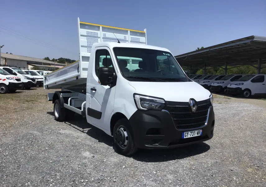 Renault Master Benne blanc en 3/4 avant droit, cabine simple, benne relevée et roues jumelées visibles.