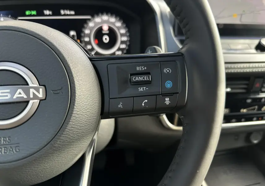 Gros plan sur le volant cuir noir du Nissan Qashqai 2025 avec commandes de régulateur de vitesse et assistance au pilotage.
