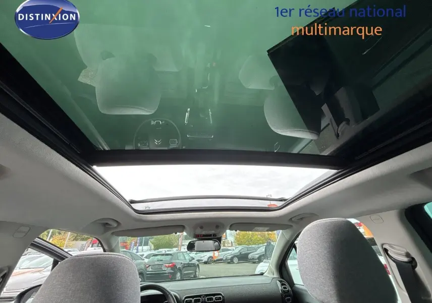 Vue intérieure du toit panoramique et tableau de bord d'une Citroën C3 Aircross gris platinium, 5 portes, 2021.