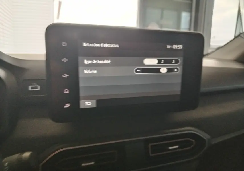 Écran tactile central affichant les réglages de détection d'obstacles dans l'habitacle du Dacia Jogger blanc.