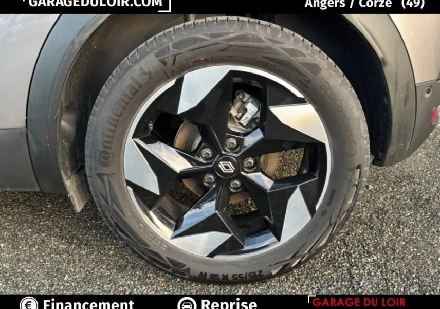 Gros plan sur la roue avant droite du Renault Captur gris foncé 2025, jante alliage noire et argentée au design géométrique.