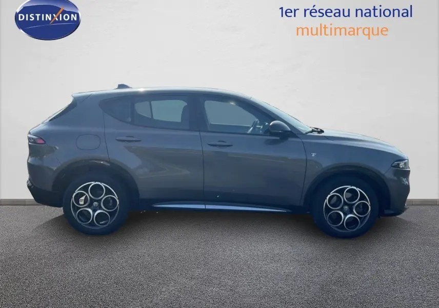 Vue latérale droite d'un Alfa Romeo Tonale gris Vesuvio métallisé, soulignant ses jantes distinctives et sa silhouette compacte.