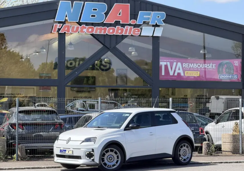 Renault R5 E-Tech blanc nacré vue 3/4 avant droit, avec jantes acier 18 pouces et signature lumineuse LED.