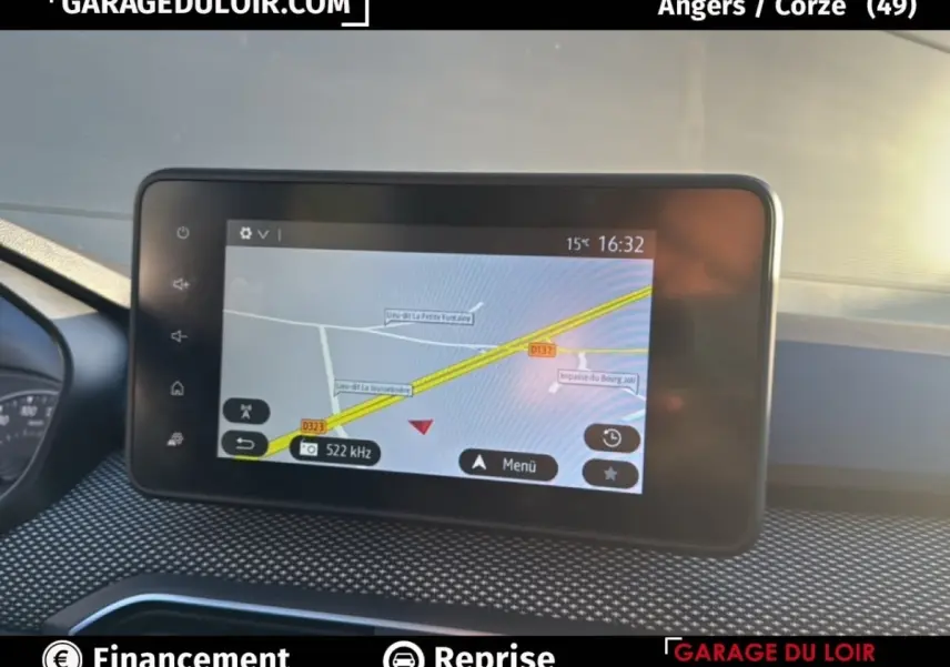 Écran tactile central affichant la navigation GPS dans un Dacia Sandero blanc, vue intérieure du tableau de bord.