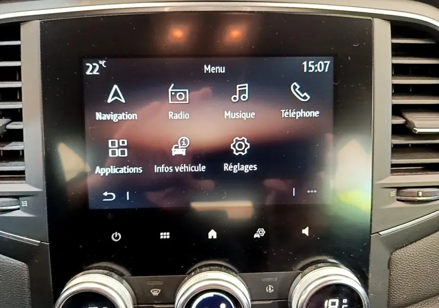 Écran tactile central du tableau de bord de la Renault Mégane Business E-Tech hybride, avec commandes climatisation visibles.