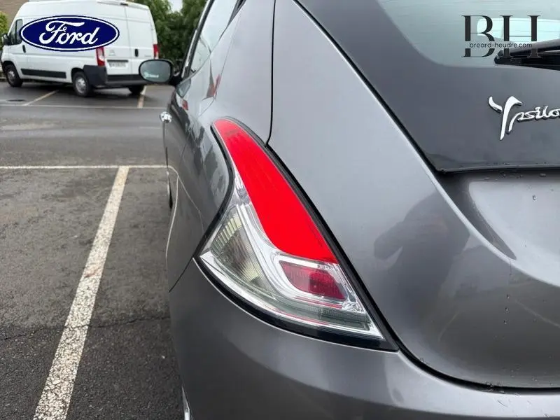 Gros plan sur le feu arrière droit d'une Lancia Ypsilon gris Argento, avec le logo Ypsilon visible sur le hayon.