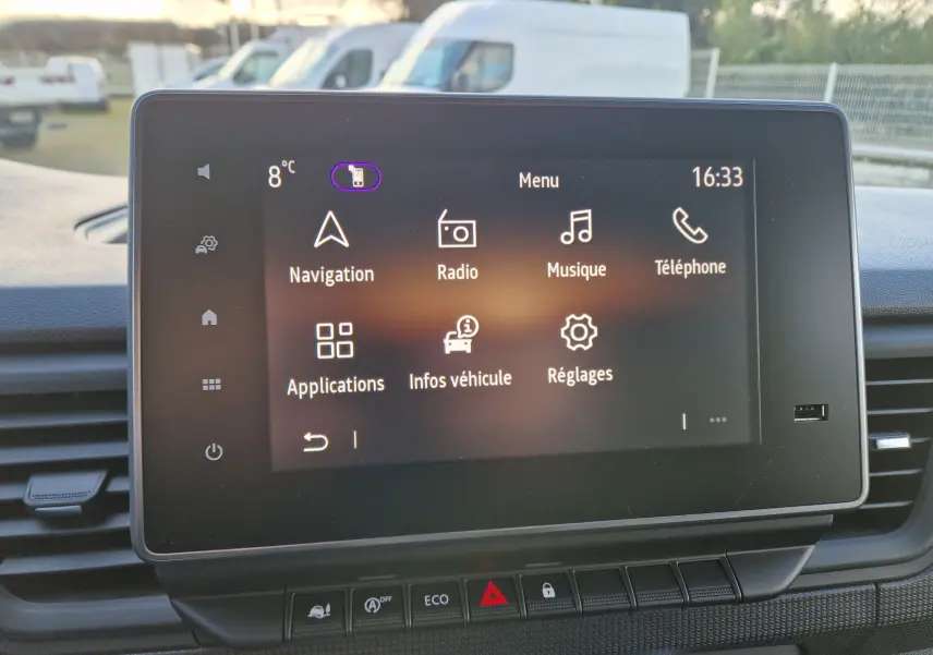 Écran tactile central du Renault Trafic Fourgon gris Highland 2025 affichant le menu principal avec navigation et radio.