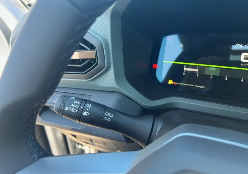 Gros plan sur le combiné d'instruments et la commande des phares du tableau de bord du Dacia Bigster gris schiste 2025.