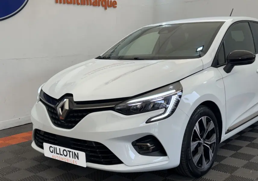 Renault Clio Evolution TCe 100 GPL blanche vue en 3/4 avant droit, avec phares LED et jantes alliage noires.