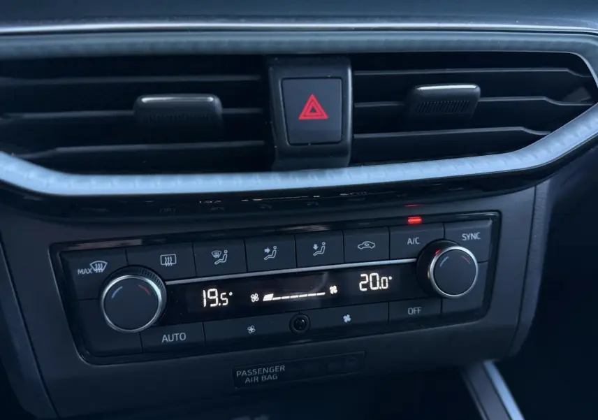 Détail de la console centrale du SEAT Arona 2025 montrant la climatisation automatique bi-zone avec réglages numériques.