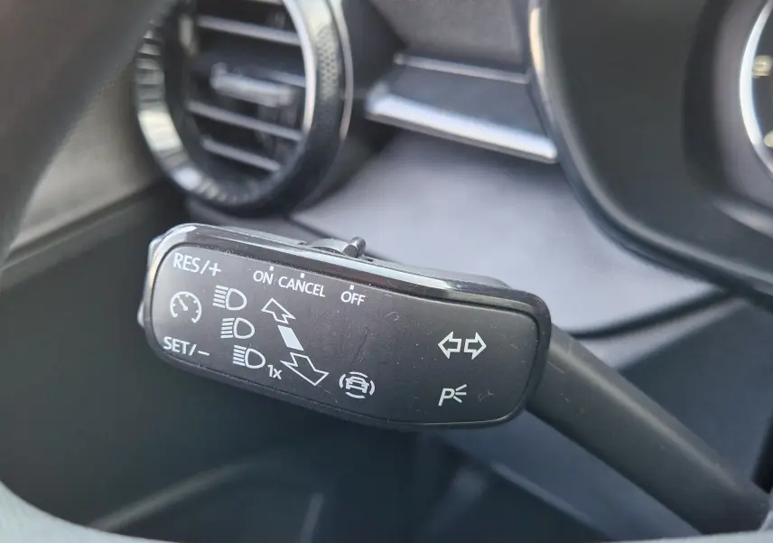 Gros plan sur la commande de régulateur de vitesse et clignotants dans l’habitacle d’une Skoda Fabia blanche 2022.