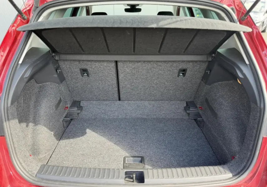 Coffre ouvert vu de l'arrière d'un SEAT Arona Rouge Désir, montrant un espace de rangement propre et spacieux.
