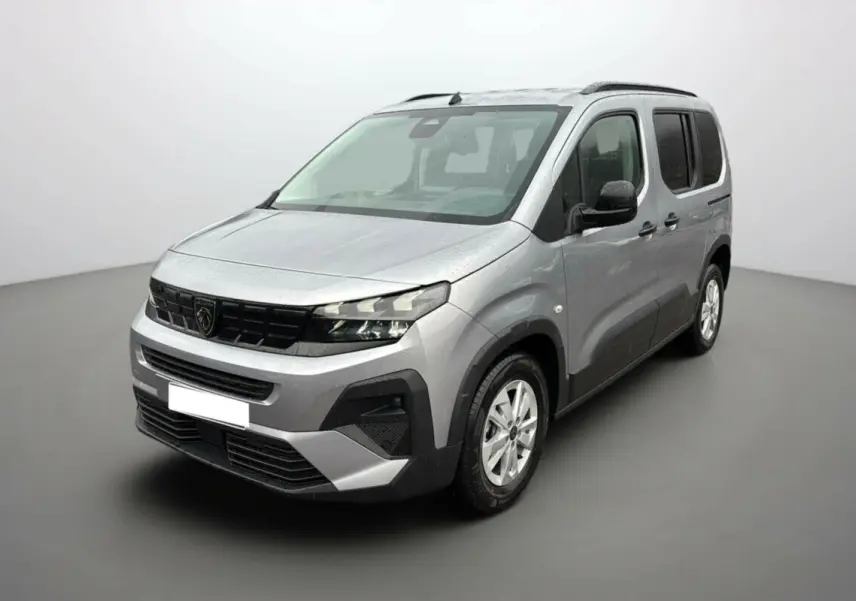 Peugeot Rifter BlueHDi 130 gris Artense en 3/4 avant droit avec barres de toit et vitres surteintées.