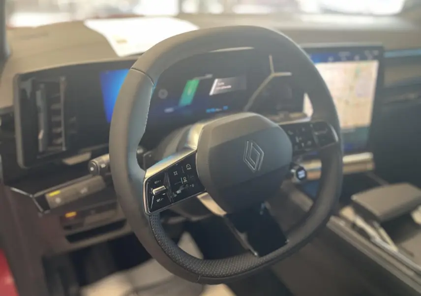 Vue rapprochée du volant Renault RAFALE 2025 avec commandes intégrées et tableau de bord numérique lumineux.