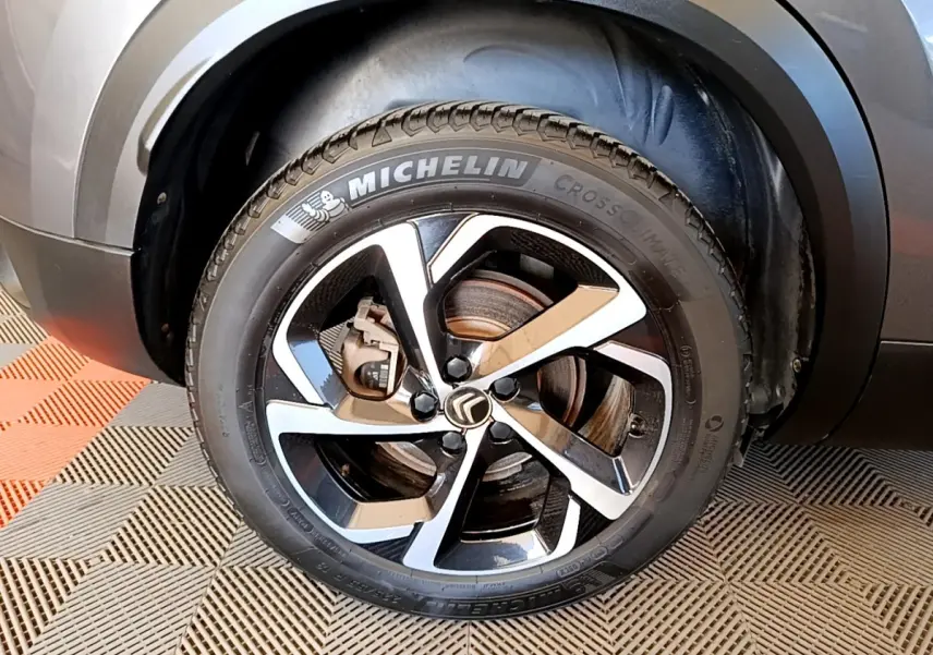 Gros plan sur la roue avant droite gris foncé du Citroën C5 Aircross avec jante alliage et pneu Michelin.