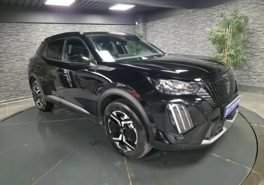 Peugeot 2008 noire vue 3/4 avant droit, avec calandre noire et jantes alliage bi-ton 17 pouces.