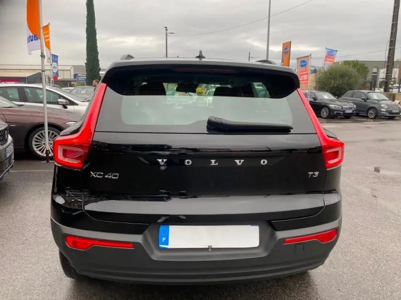 Vue arrière d'un Volvo XC40 T3 noir solid avec feux arrière en forme de L et plaque d'immatriculation française visible.
