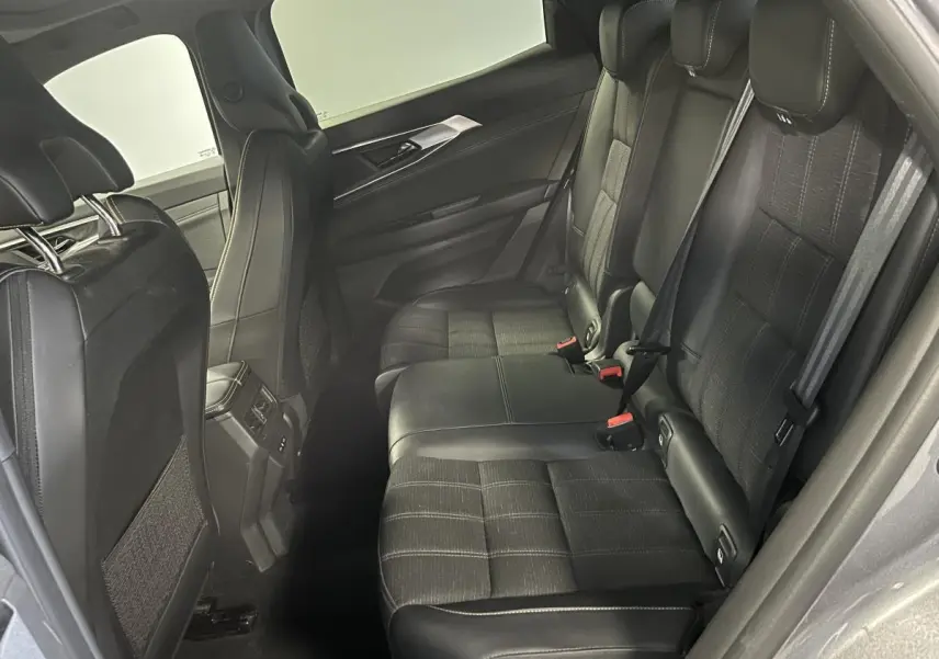 Vue côté droit de la banquette arrière noire mixte cuir et tissu du Renault Austral gris 2024 avec surpiqûres or.