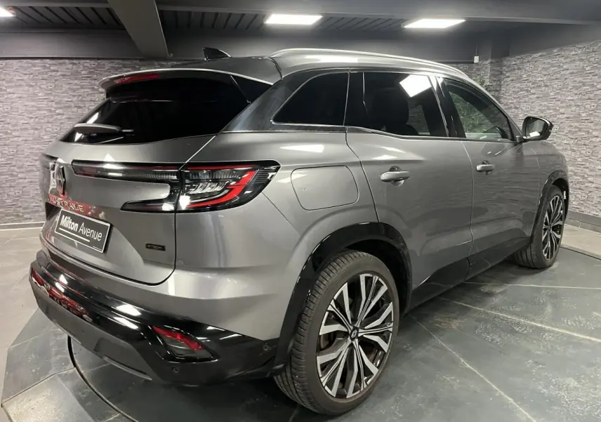 Renault Austral gris en 3/4 arrière droit, avec jantes alliage 20 pouces et toit noir panoramique.