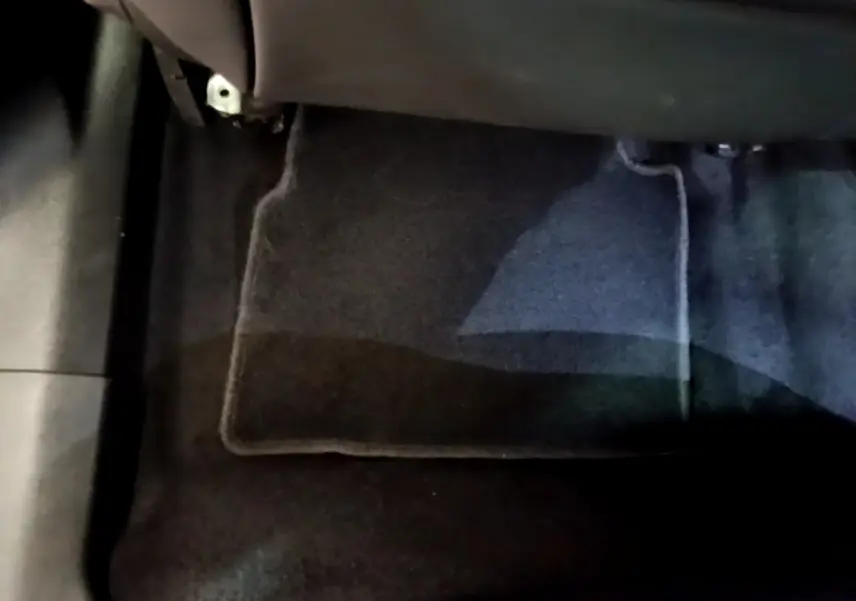 Gros plan sur le tapis de sol noir côté passager avant d’un Peugeot 2008 gris clair de 2021.